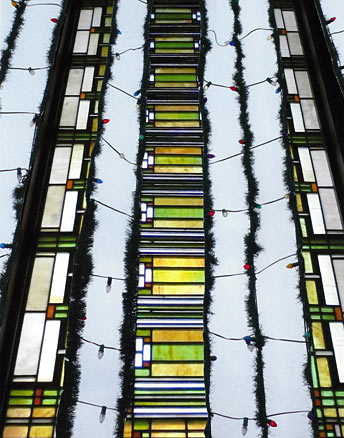 grid of Xmas lights with stained glass window