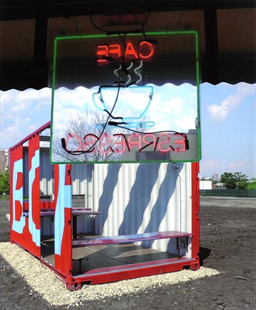 Neon sign with view of storage-container art installation