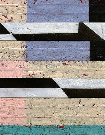Black and white stripes interrupt blocks of pastel colors painted on brick