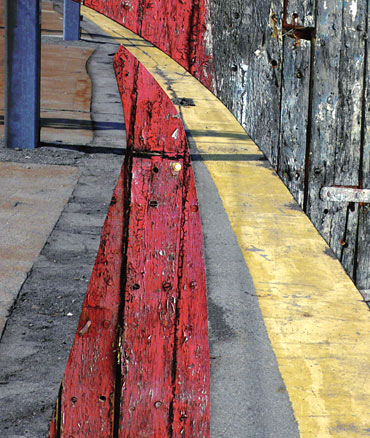 Red, black, grey vertical lines, and blues columns, transected by arching yellow line